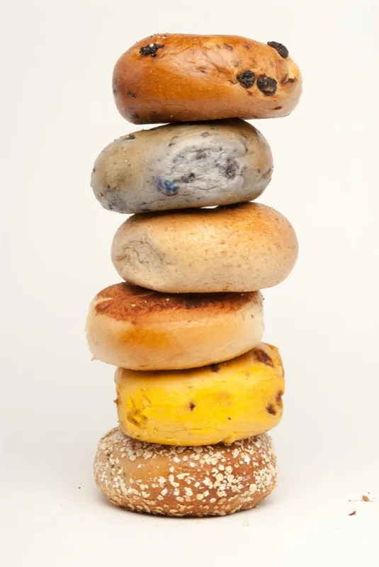 Tall stack of fresh-baked bagel varieties
