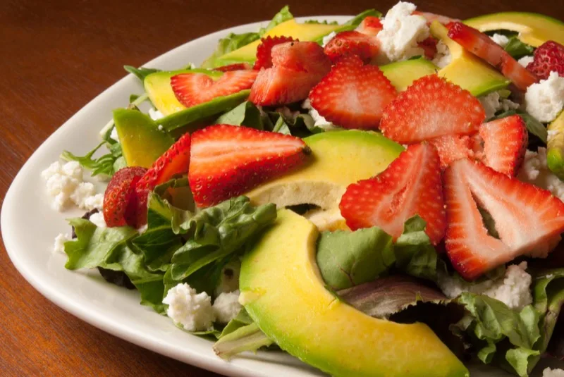 Chicken strawberry avocado salad with feta and greens